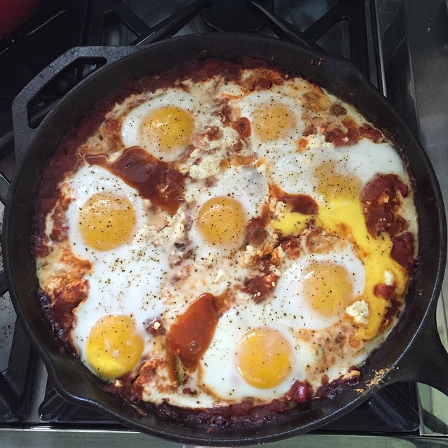 breakfast pizza with three eggs on top of it