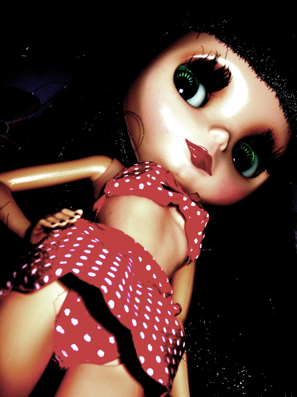 a doll with big eyes and green eyes