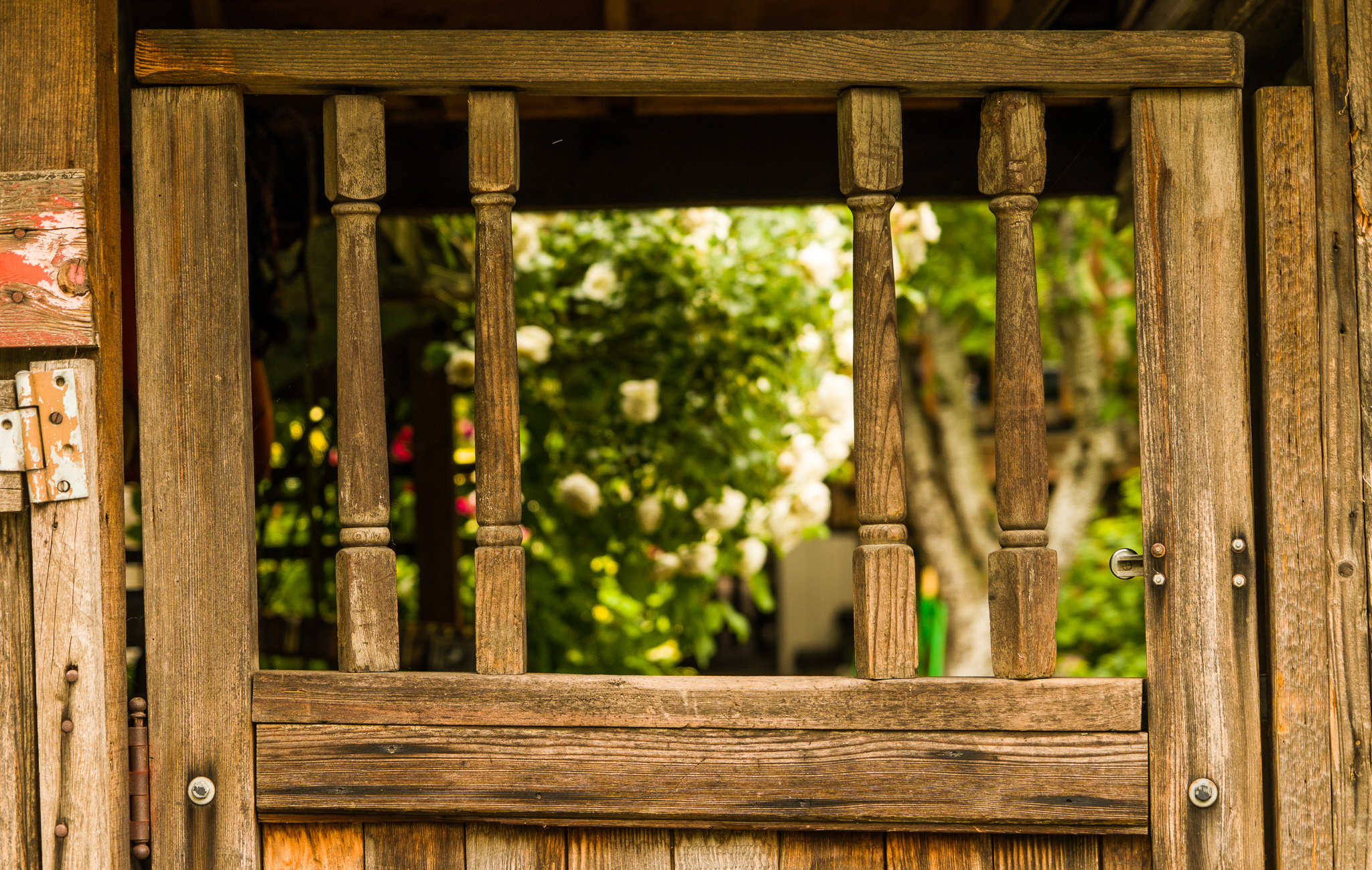 the open window of an old building with a small statue in the background