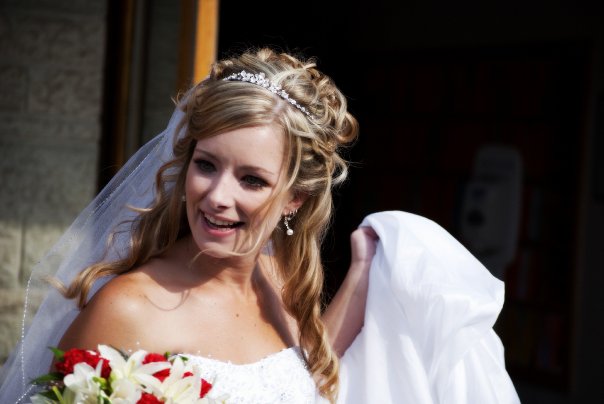 a bride looking over her shoulder holding a bouquet