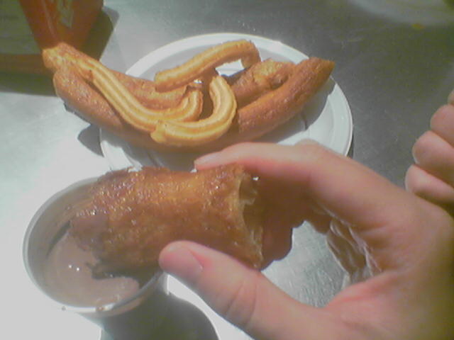 two hands holding some food on top of a table