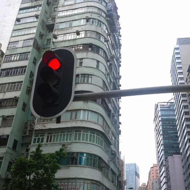 a stop light at an intersection in front of tall buildings