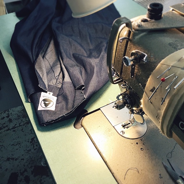 a sewing machine with a shirt and pants on it