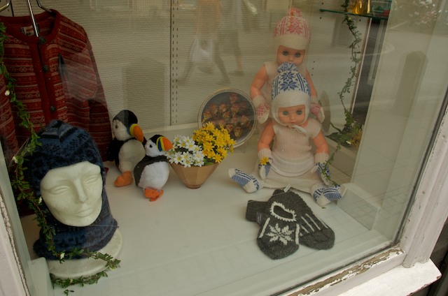 an assortment of stuffed animals in a glass case