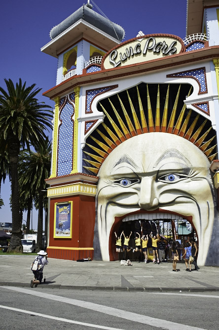 the entrance to a carnival has large sun decorations