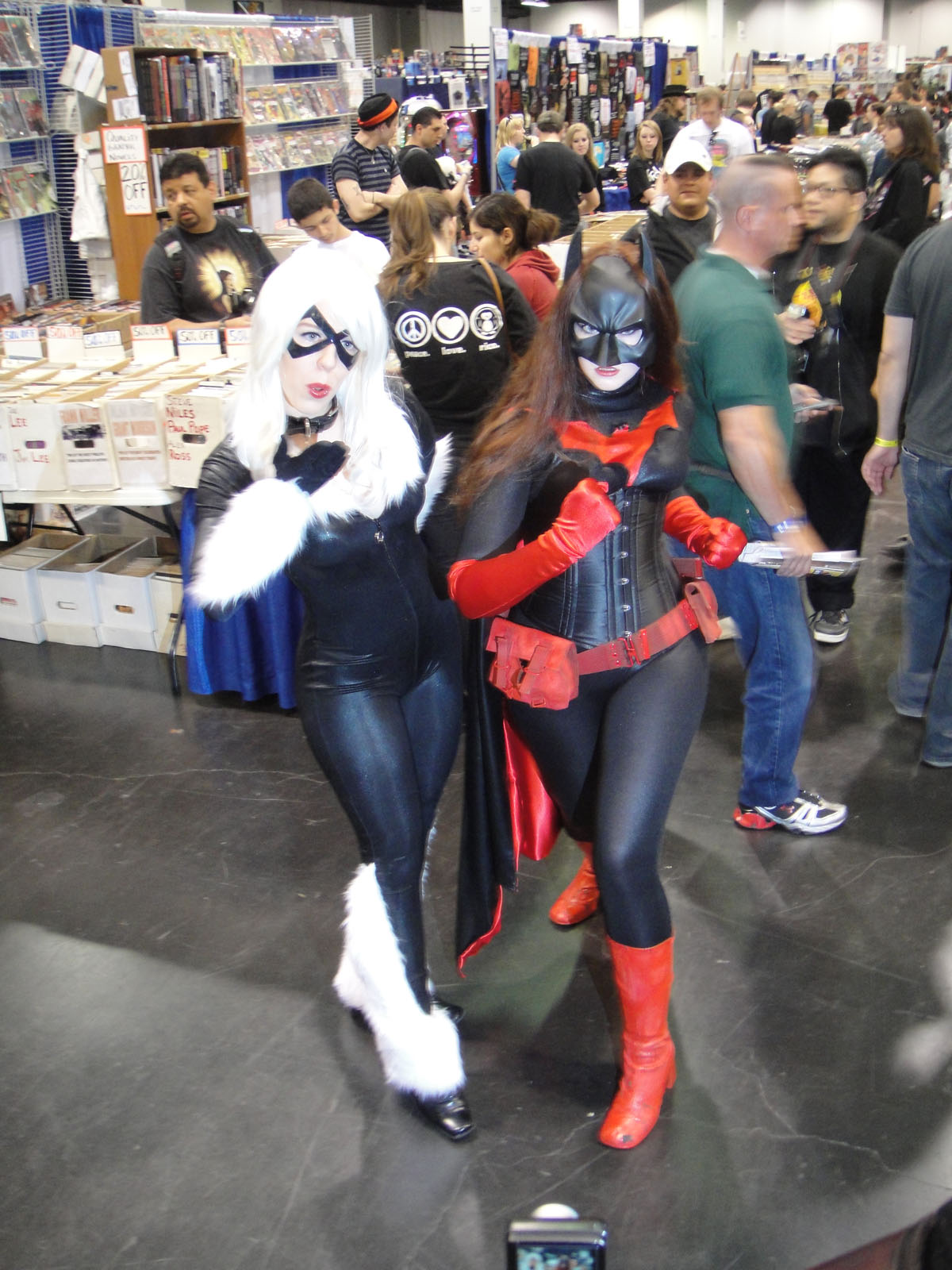 three costumed women pose for the camera inside a store