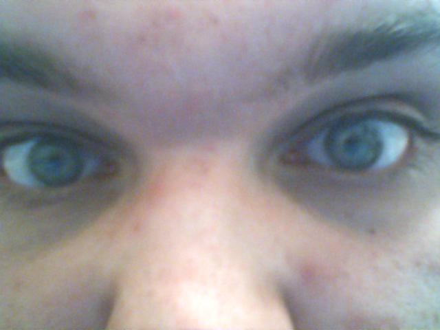 a close up po of a person's blue eyes