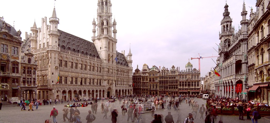 people are walking around in an old european street