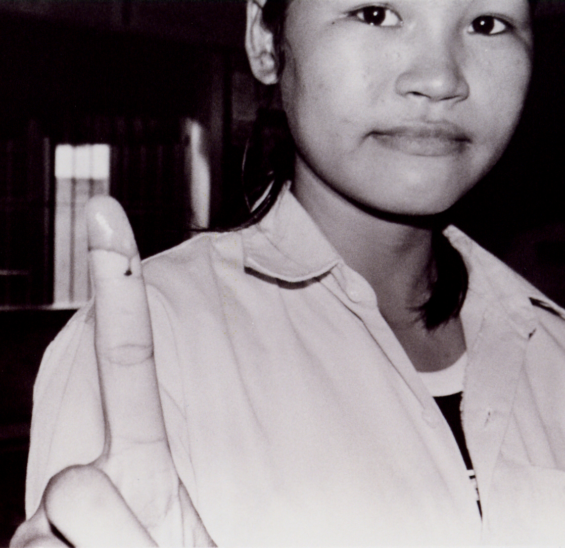 a little girl holding an object and pointing