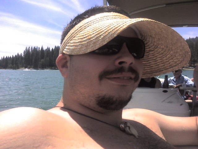 a man with a large straw hat is on a boat