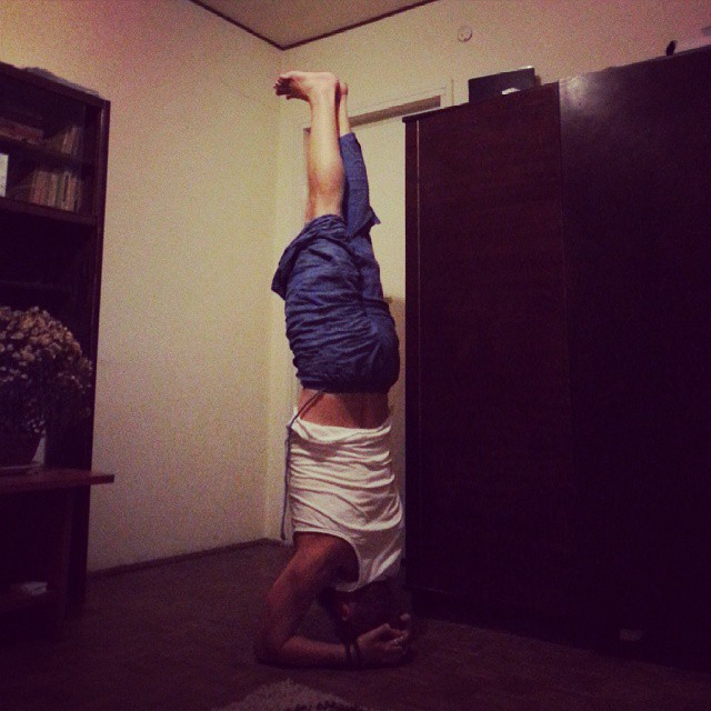 a man doing a handstand in front of a wall