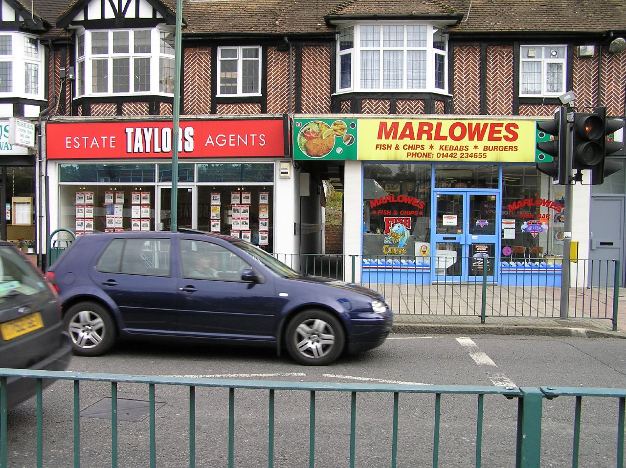 the street is filled with cars outside of stores