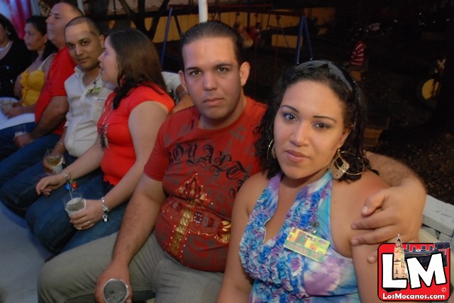 people sitting at a bar with a glass in their hand