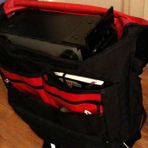 a red bag with two open laptop computers in it