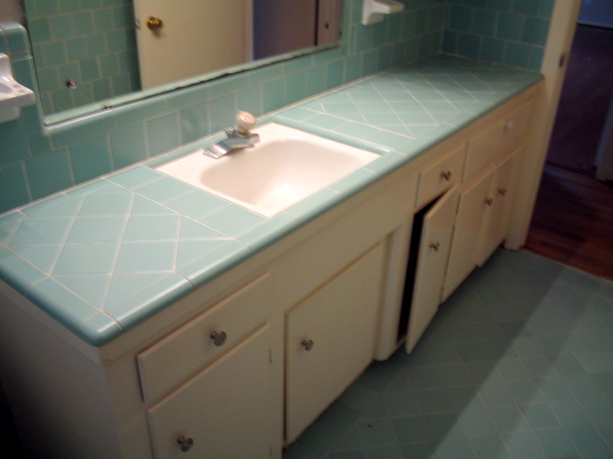 a bathroom scene complete with one single sink and cabinetry