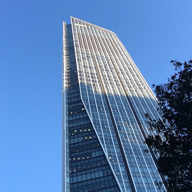 a very tall building standing next to a tree