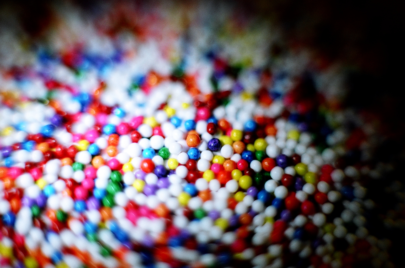 a bunch of tiny colorful beads are scattered
