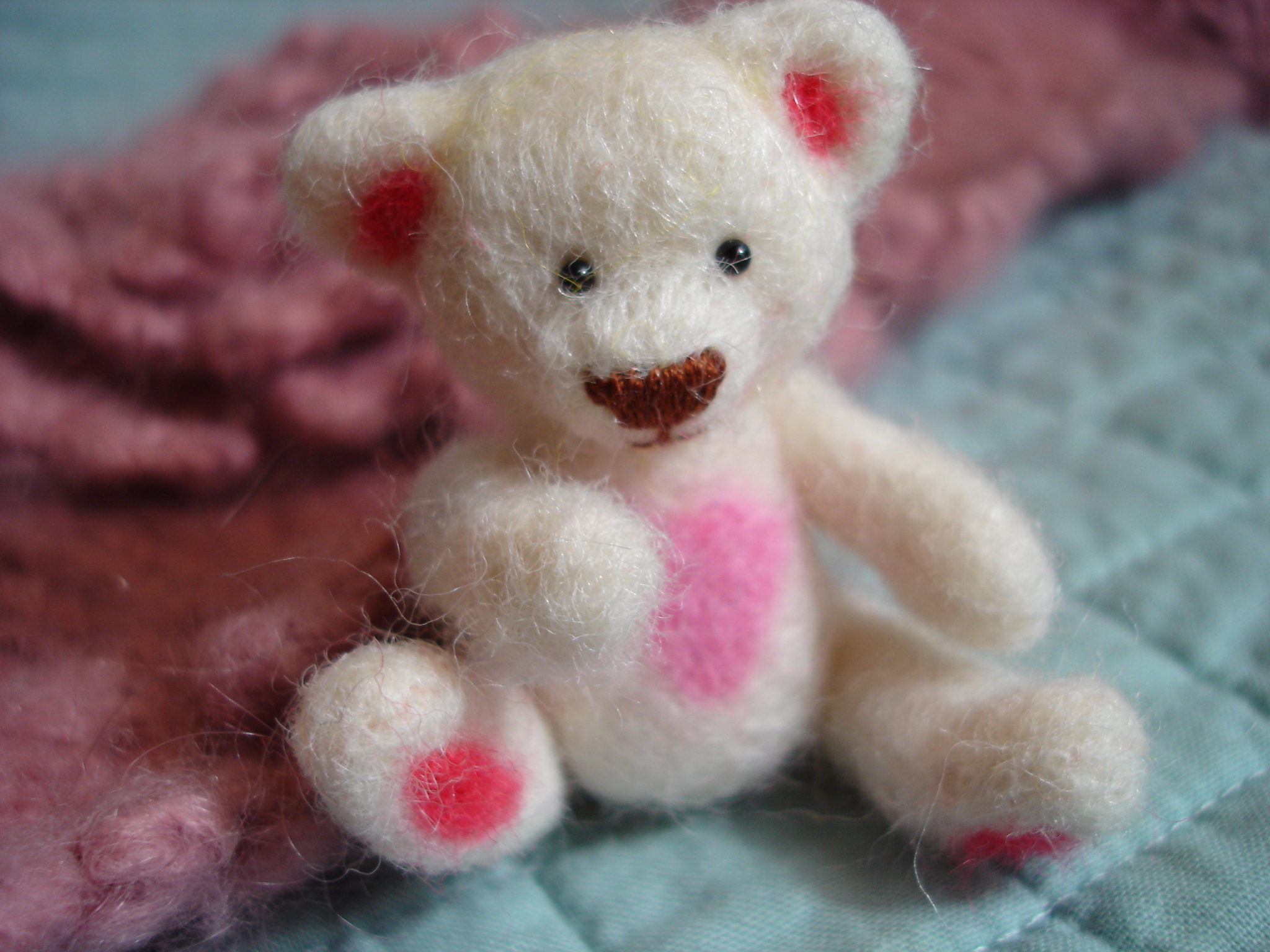 a white stuffed animal with pink spots on it