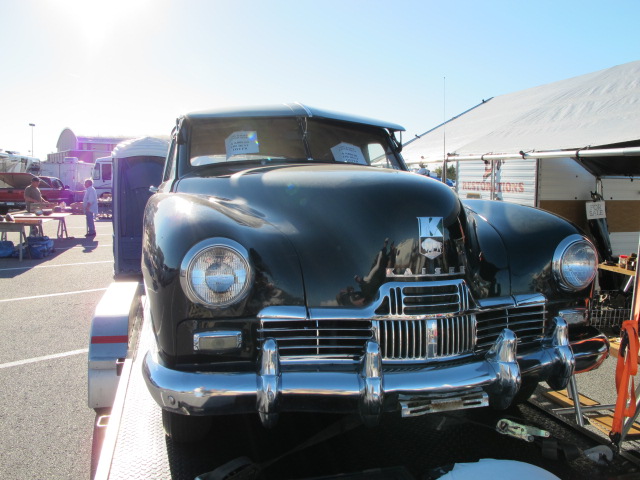 a black classic car on display at a car show