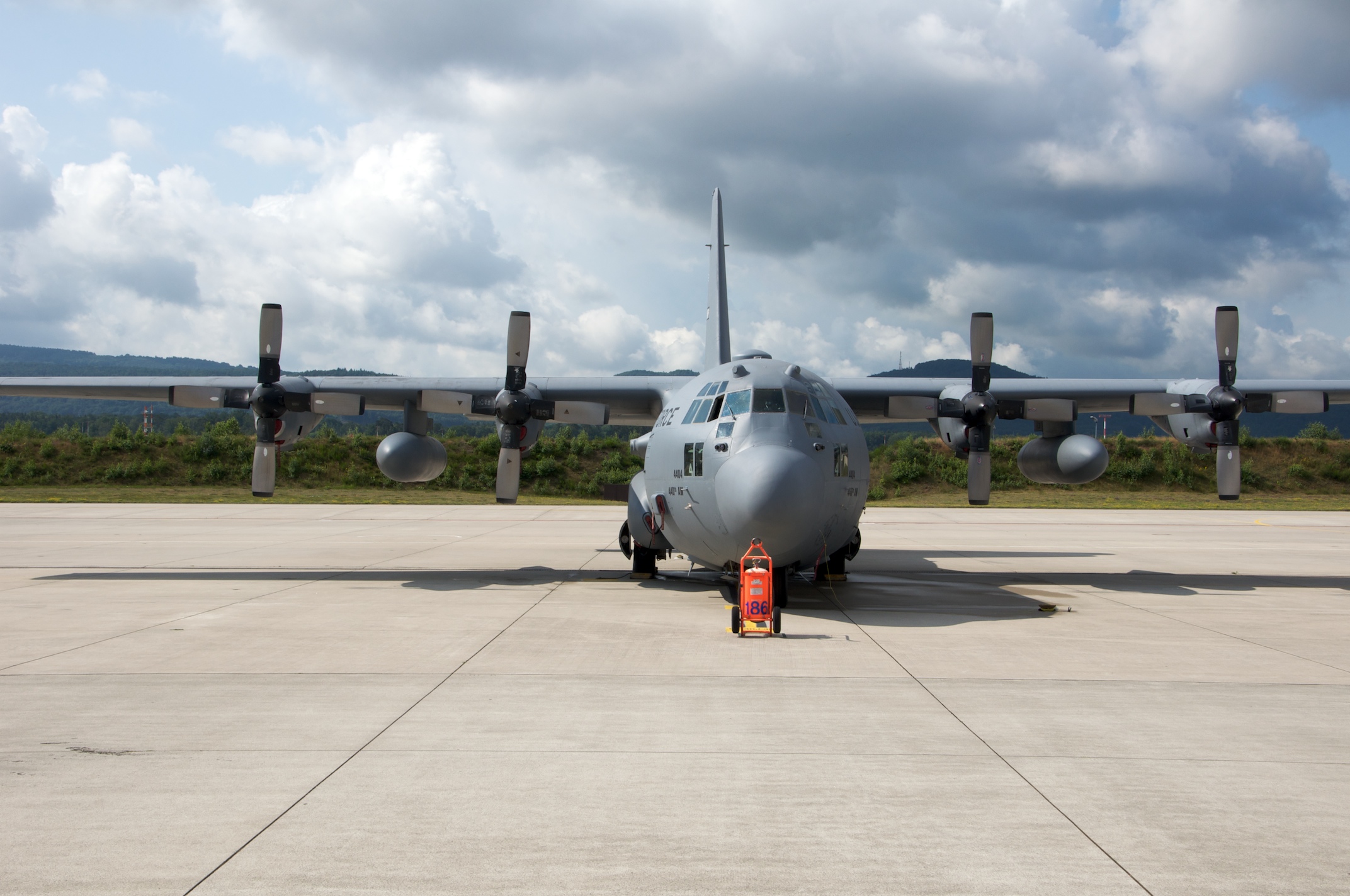 an airplane is parked in front of some planes