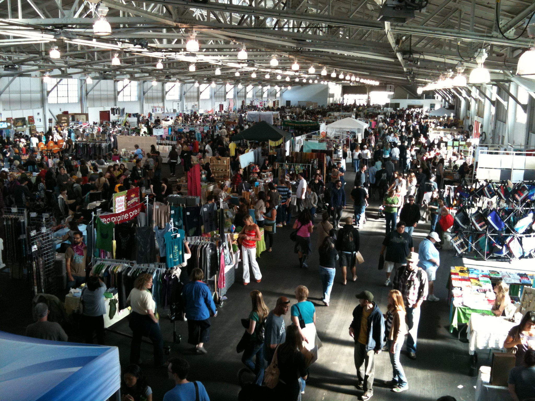 many people are shopping at an indoor market