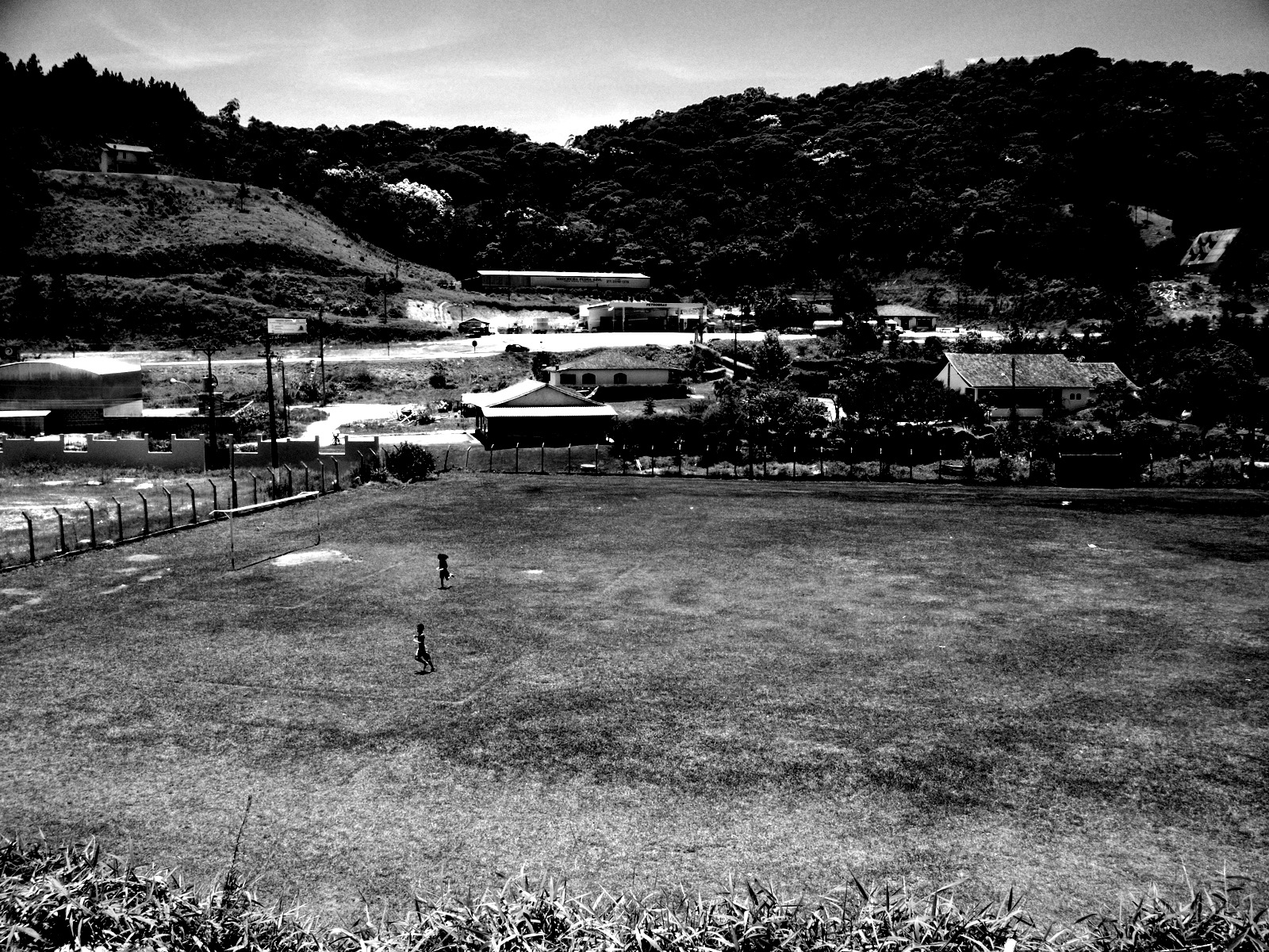 an empty baseball field in a rural neighborhood