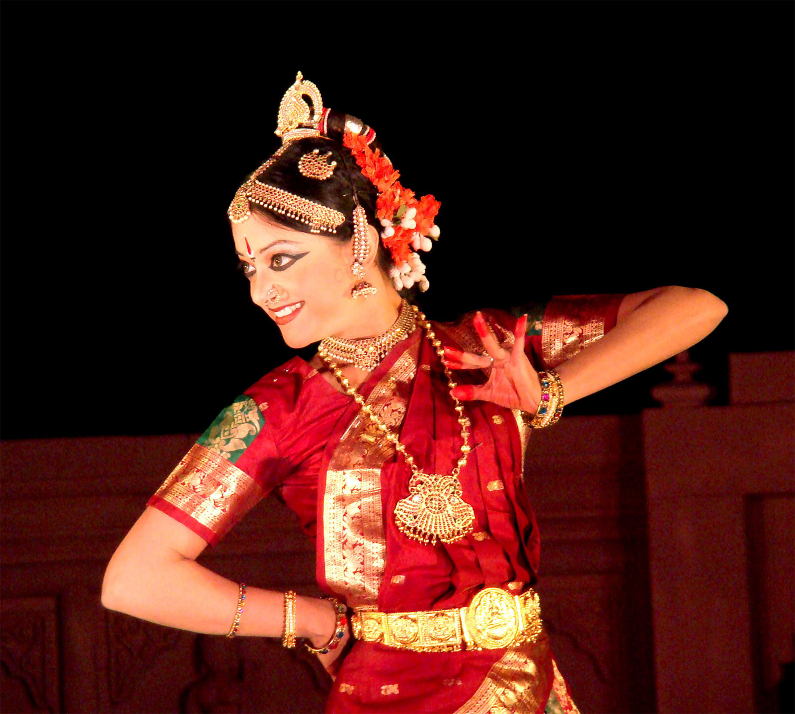 a woman in a red and gold costume