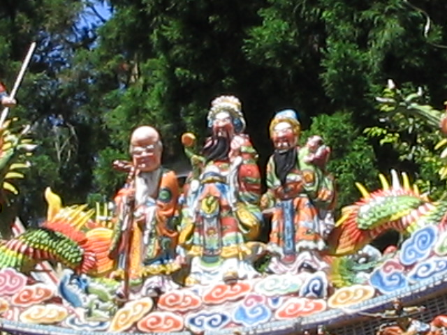 an elaborate sculpture of buddhas in front of trees