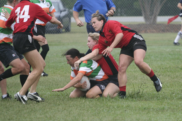 several people are playing rugby in an outdoor field