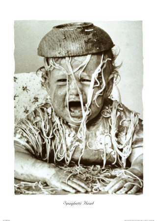 an old pograph of a little boy with spaghetti everywhere
