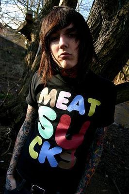 a girl with dark hair and tattoos in a shirt saying meat sucks
