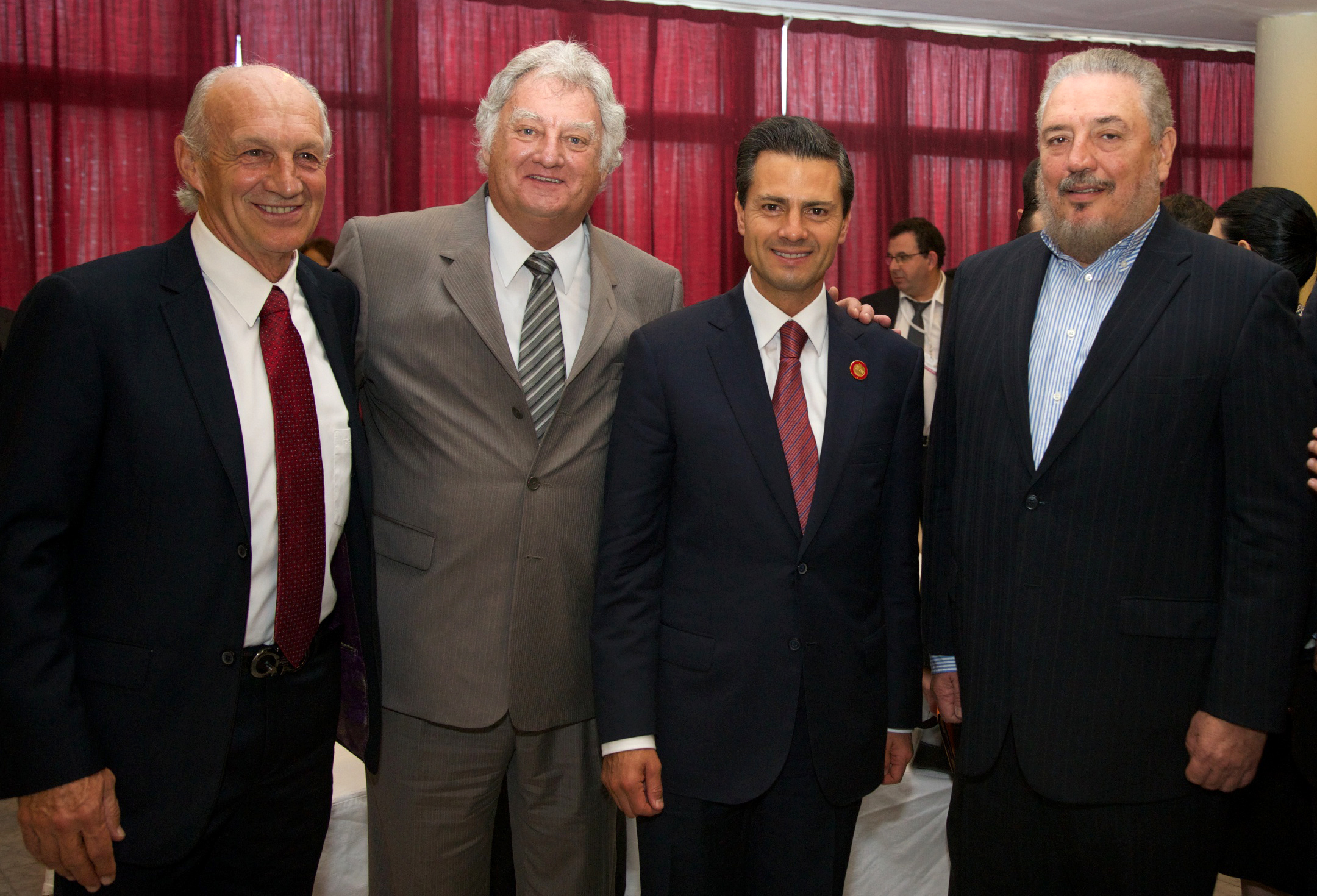 a group of men in business attire posing for a po