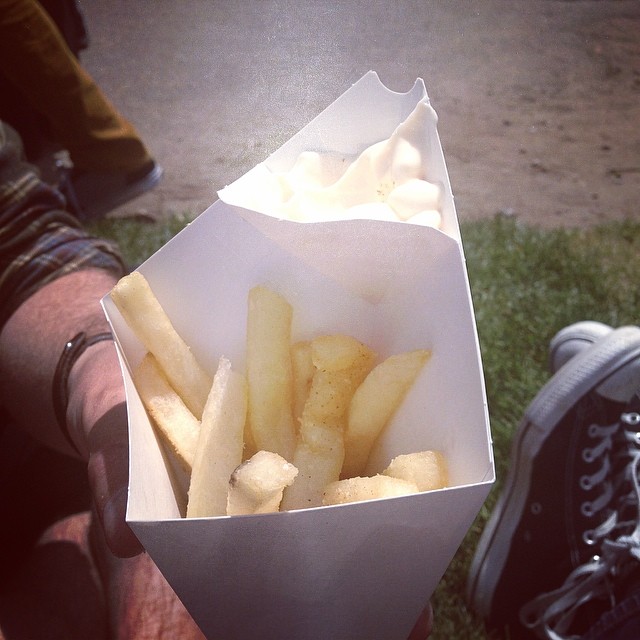 a man holding a box of fries in his hand