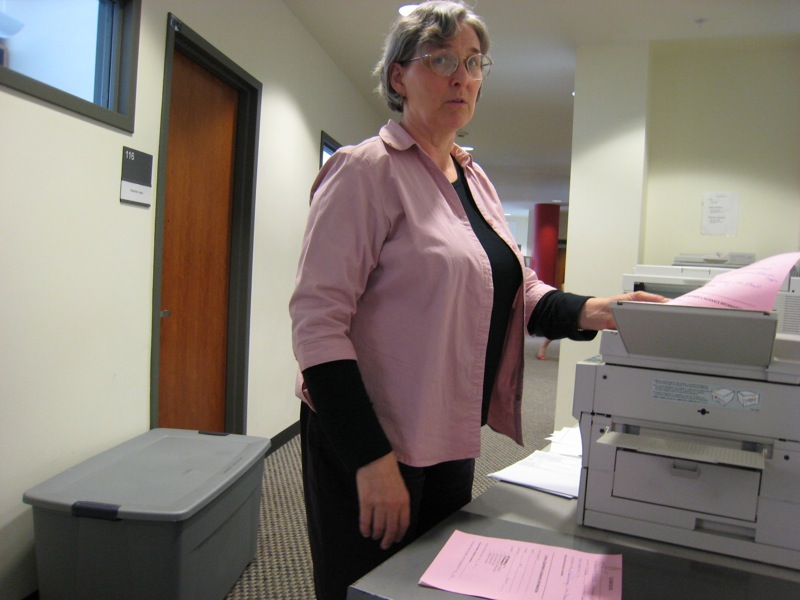 woman holding out a large copy machine in front of her