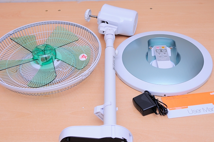 a white table with a fan on top of it and batteries