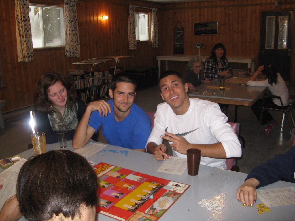 a group of friends are sitting together at a restaurant table