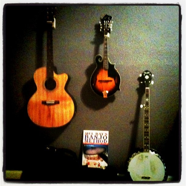 three guitars are sitting on the wall