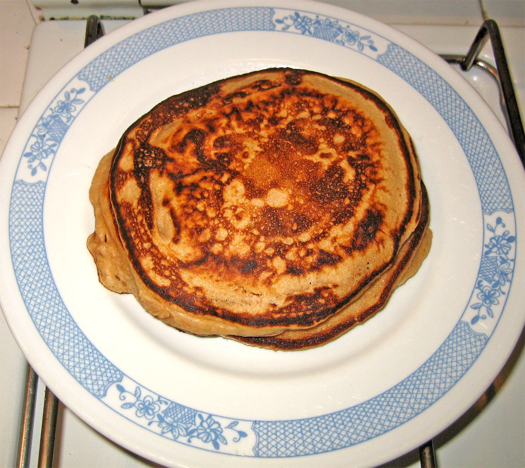 pancakes are sitting on a blue and white plate