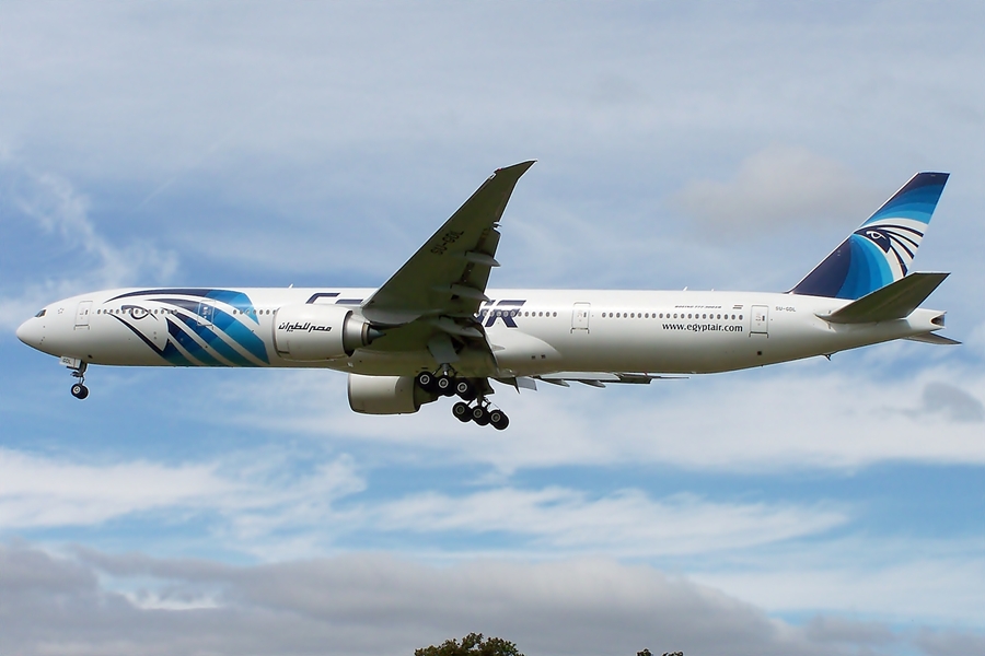 a blue and white plane in the sky