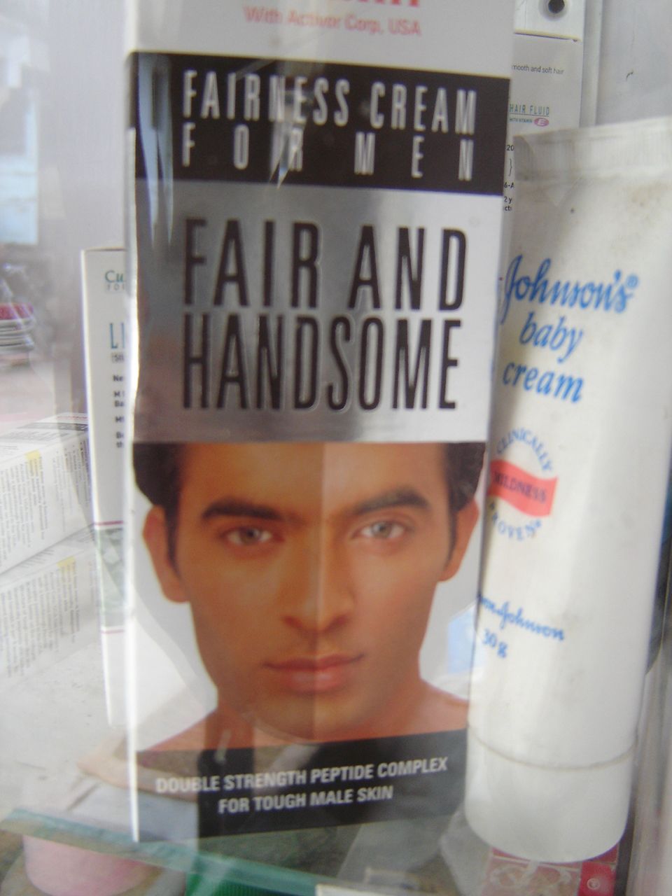 a poster of the face of a guy on a store shelf