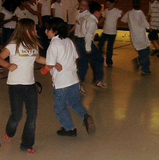 a group of girls are dancing and talking