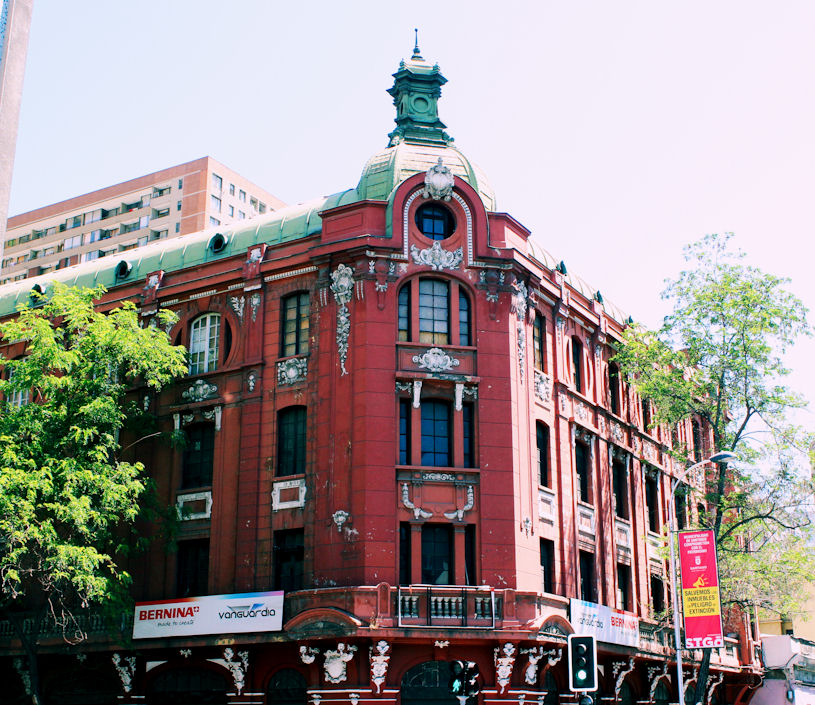 red and white building with trees and tall buildings