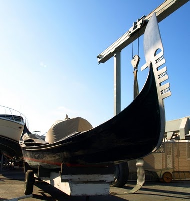 a black boat parked in front of a sign that reads deep