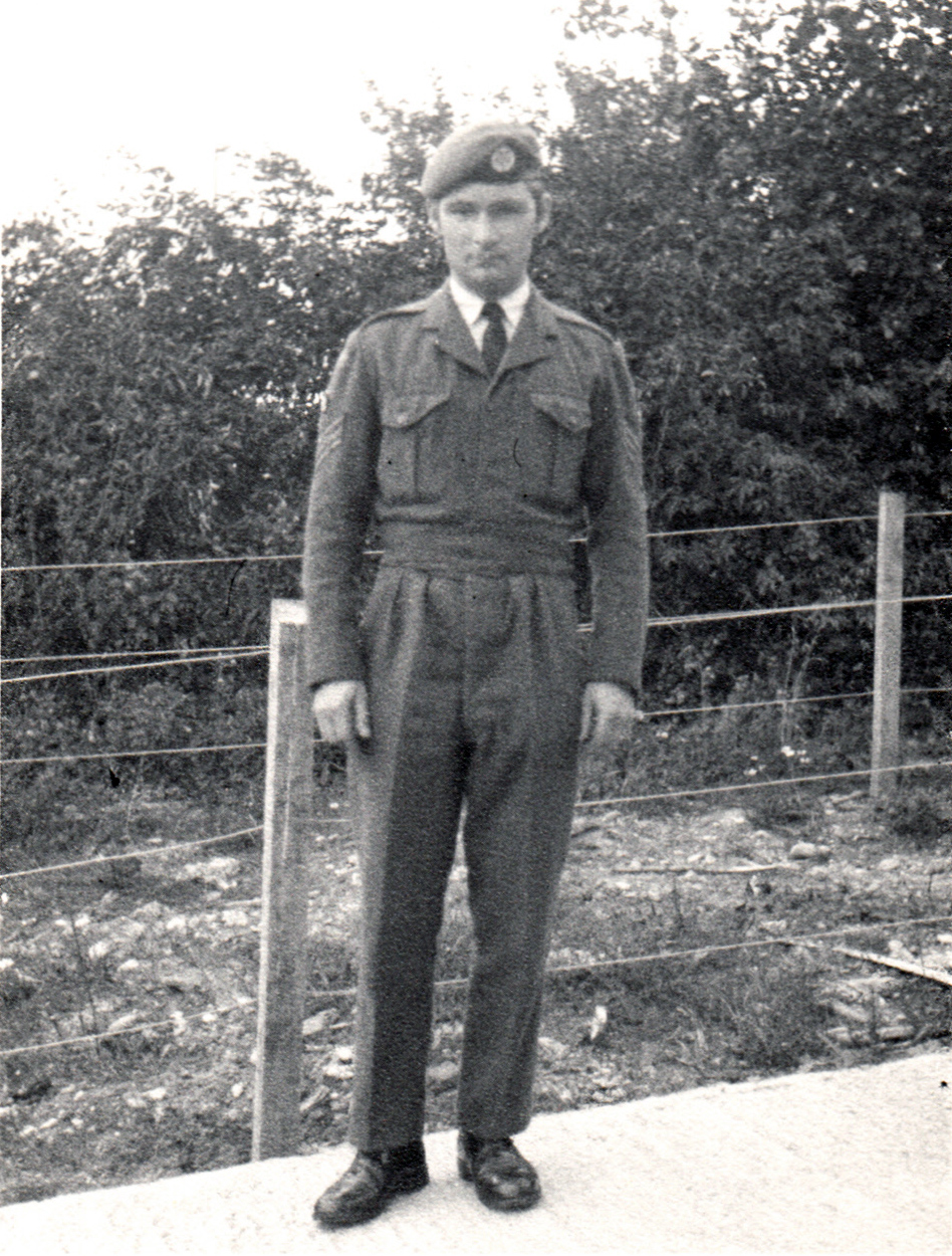 a man wearing a uniform standing on sidewalk
