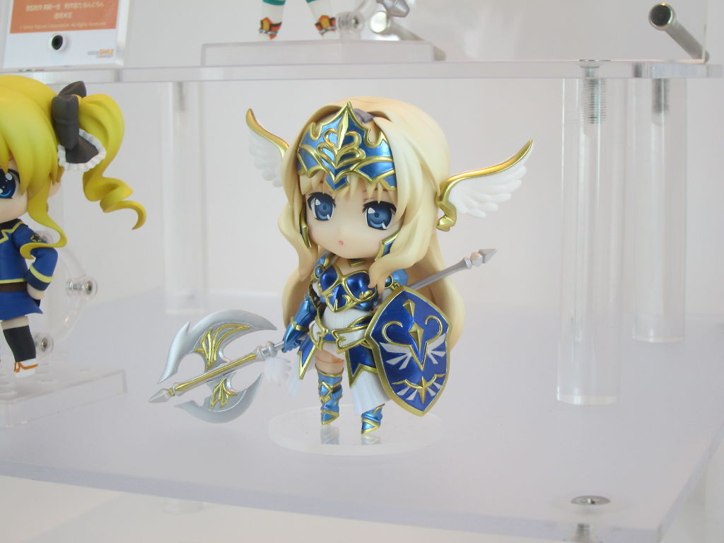 two anime figurines sitting in clear cases