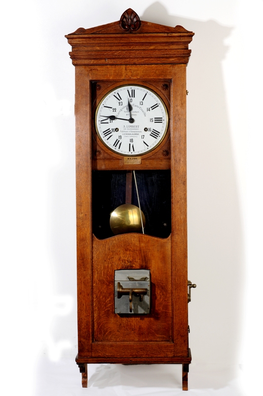 a clock with bells mounted on it by the wall