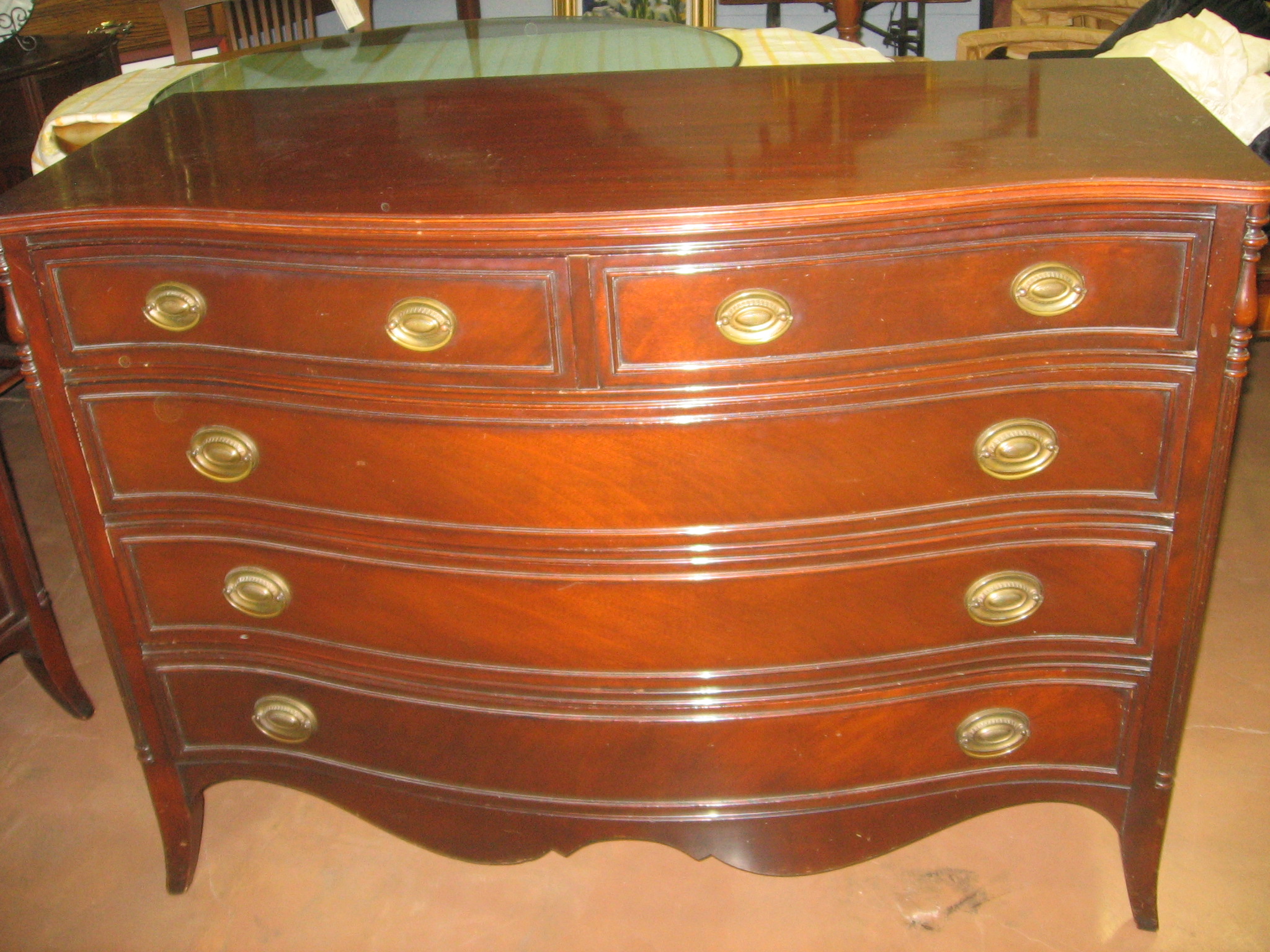 a chest of drawers that have ss handles