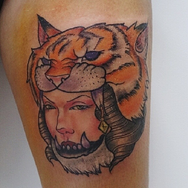 a woman has a tiger hat on her head