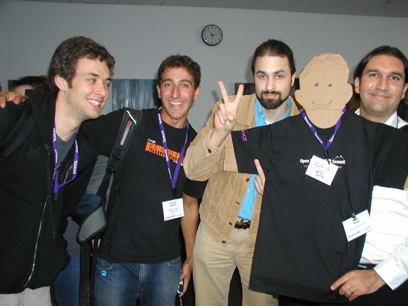 a group of men standing next to each other holding their fingers up