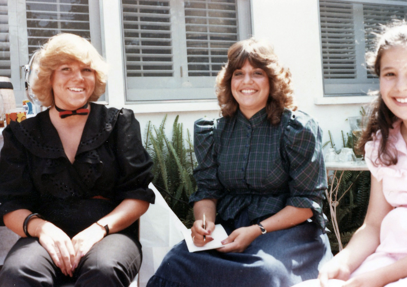 two women sitting next to each other on steps